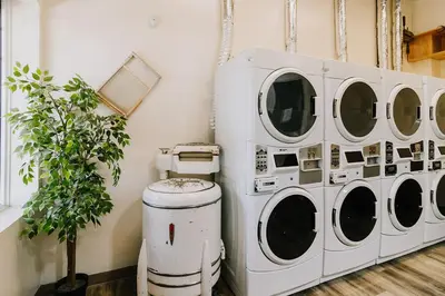 a group of four washing machines in a room at Adventure Knap Shack in Nordegg