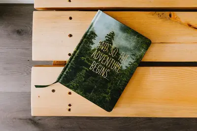 a book sitting on top of a wooden table at Baldy- Modern tiny home in historic Nordegg in Nordegg