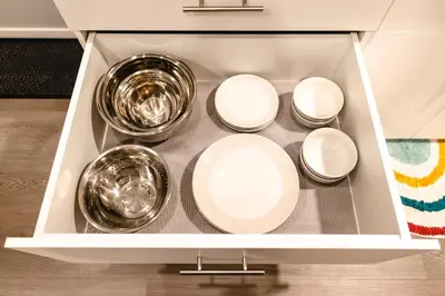 a drawer with four bowls and plates in it at Baldy- Modern tiny home in historic Nordegg in Nordegg