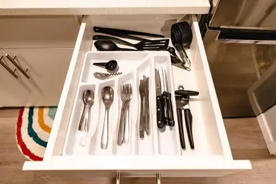 a drawer with silver utensils in a cabinet at Coliseum - Get Back to Nature in Nordegg