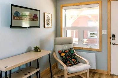 a chair in a room with a desk and a window at Trailhead Tuck-Inn in Nordegg