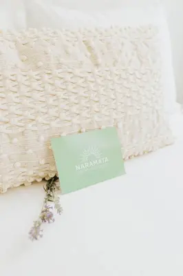 a white blanket with a card on top of it at Naramata Courtyard Suites in Naramata