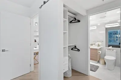 a white bathroom with a toilet and a sink at Executive Downtown Suite with Great City Views in Vancouver