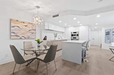 a kitchen and dining room with a glass table and chairs at Executive Downtown Suite with Great City Views in Vancouver