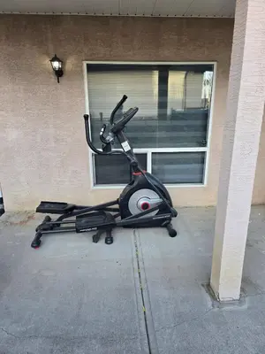 a exercise bike parked in front of a building at Cozy 2-Bedroom Suite 5 Minutes Walk to Chestermere Lake in Chestermere