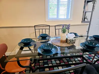 a glass table with four blue bowls on it at The open nest in Delta