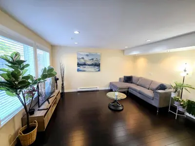 a living room with a couch and a tv at The open nest in Delta