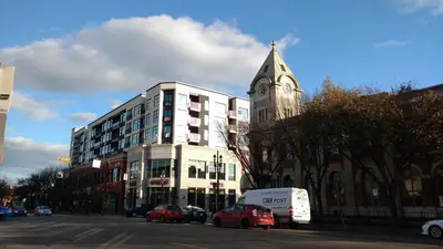 a building with a clock tower and a building with cars at Condo Unit-UofA, UofA Hospital, Whyte Ave, Trails! in Edmonton