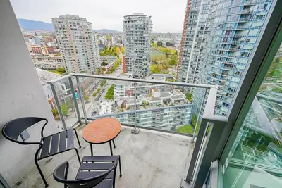 a balcony with a table and chairs on a building at Gorgeous Unit with Beautiful City Views in Vancouver