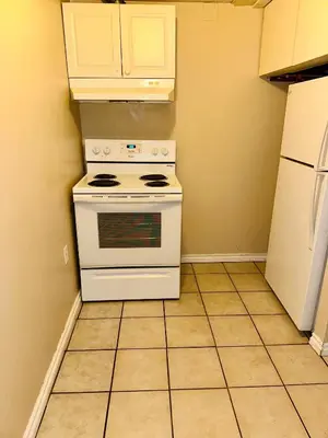 a kitchen with a white stove and refrigerator at The house Londonderry mall in Edmonton