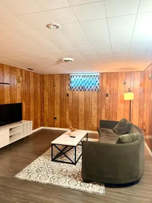a living room with a couch and a table at The house Londonderry mall in Edmonton