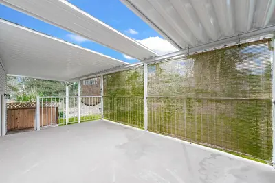 an empty screened in porch with large windows at Vancouver Lake City Way Guesthouse 10 min to SkyTrain in Burnaby