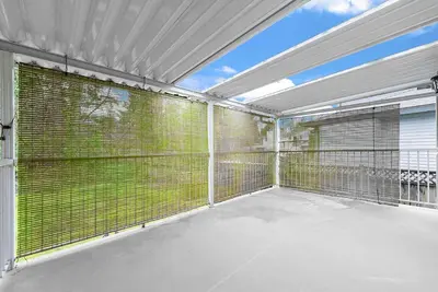 a large covered patio with a large window at Vancouver Lake City Way Guesthouse 10 min to SkyTrain in Burnaby