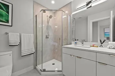 a bathroom with a shower and a sink at Vancouver Lake City Way Guesthouse 10 min to SkyTrain in Burnaby
