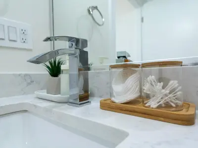 a kitchen counter with a sink and a faucet at Quiet, cozy 2BR1BA private entry suite near Skytrain in Vancouver