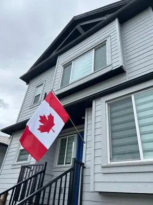 a canadian flag on the front of a house at Quiet, cozy 2BR1BA private entry suite near Skytrain in Vancouver