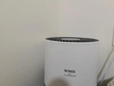 a white wifi router sitting next to a wall at Quiet, cozy 2BR1BA private entry suite near Skytrain in Vancouver