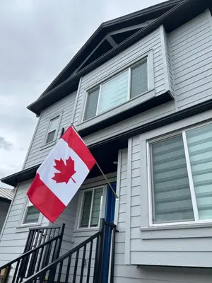 a canadian flag on the front of a house at Quiet, cozy 2BR1BA private entry suite near Skytrain in Vancouver