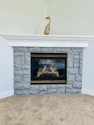 a stone fireplace with a vase on top of it at Acreage, 5 bdrm, King Bed, AC, Wood Fireplace, Rural in Balzac