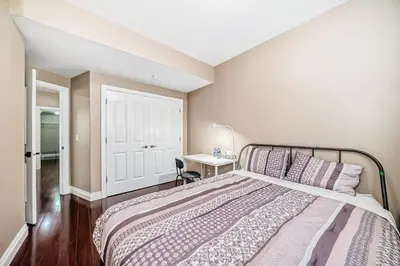 a bedroom with a bed and a desk with a lamp at Cozy bedroom in quiet community in Calgary