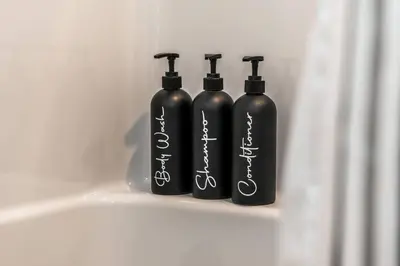 a group of three black bottles sitting on a shelf at ExoticLUSHquietRetreatKingBed|WIFI|Parking|WEM in Edmonton