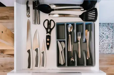 a white drawer filled with utensils at Bikepack Basecamp in Nordegg
