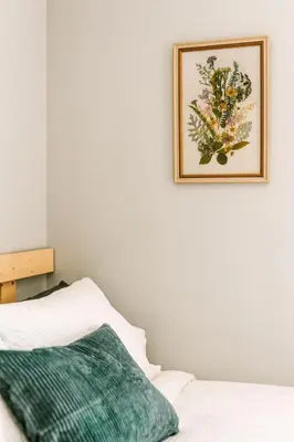 a picture hanging on a wall above a bed at Bikepack Basecamp in Nordegg