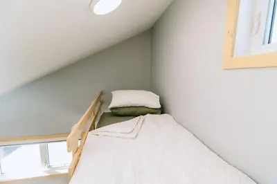 a bedroom with a bunk bed in a attic at Bikepack Basecamp in Nordegg
