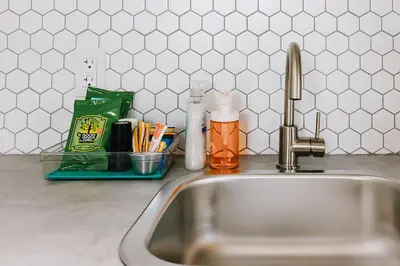 a kitchen sink with a faucet and utensils at Roamer's Nook in Nordegg