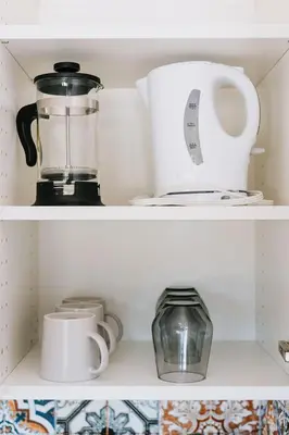 a shelf with a blender and other kitchen items at Roamer's Nook in Nordegg