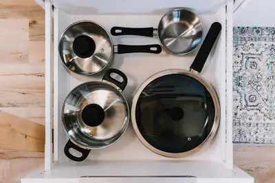 four pots and pans in a white box at Roamer's Nook in Nordegg