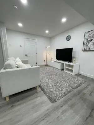 a living room with a couch and a flat screen tv at Comfy 2 Bedroom Suite Getaway in Edmonton