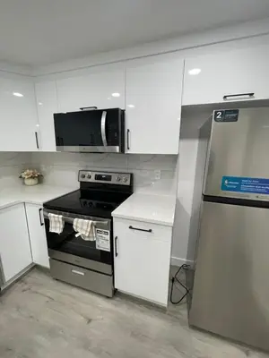 a kitchen with a stove and a microwave at Comfy 2 Bedroom Suite Getaway in Edmonton