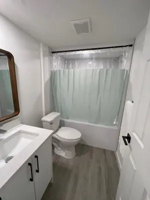 a white bathroom with a toilet and a sink at Comfy 2 Bedroom Suite Getaway in Edmonton
