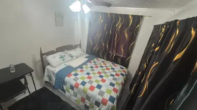 a small bedroom with a bed with a wooden headboard at The Peaceful Pines in Terrace