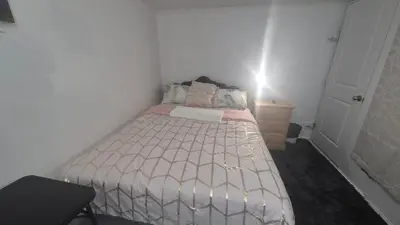 a small bedroom with a bed and a dresser at The Peaceful Pines in Terrace