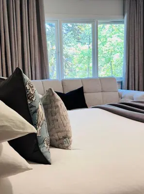 a bedroom with a bed with pillows and a couch at Charming Queen Bedroom with Bathroom Vancouver West in Vancouver