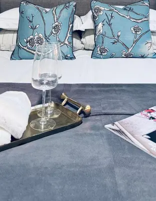 a tray with a wine glass on top of a bed at Charming Queen Bedroom with Bathroom Vancouver West in Vancouver