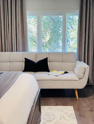 a living room with a couch in front of a window at Charming Queen Bedroom with Bathroom Vancouver West in Vancouver