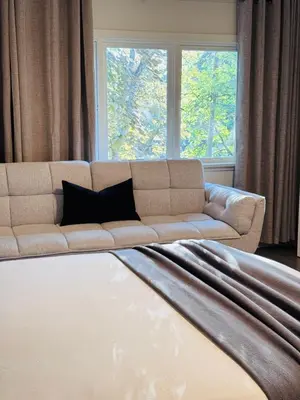 a living room with a couch in front of a window at Charming Queen Bedroom with Bathroom Vancouver West in Vancouver