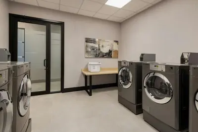 a laundry room with washing machines and a table at Fairfield Inn & Suites by Marriott Chilliwack in Chilliwack