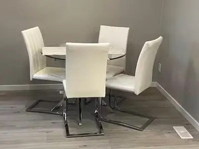 three white chairs and a table in a room at Bedroom in Keswick C in Edmonton