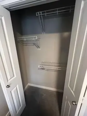 a walk in closet with a white door and shelves at Bedroom in Keswick C in Edmonton