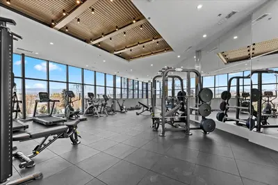 a gym with treadmills and machines in a building at Gyrobeachescape in Kelowna