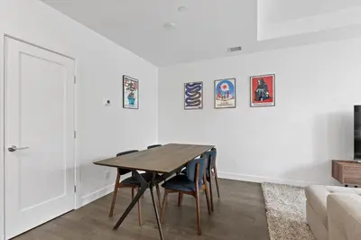 a dining room with a wooden table and chairs at Gyrobeachescape in Kelowna