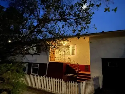 a house with a fence in front of it at Merlot House in Calgary