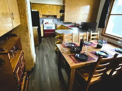 a kitchen with a wooden table with wine glasses on it at Merlot House in Calgary