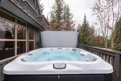 a hot tub on the back of a house at Arrowhead Point 2 by Outpost Whistler in Whistler