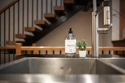 a bottle of alcohol sitting on top of a sink at Fitzsimmons Walk 10 by Outpost Whistler in Whistler