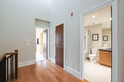 a hallway with a bathroom with a toilet and a sink at Fitzsimmons Walk 10 by Outpost Whistler in Whistler